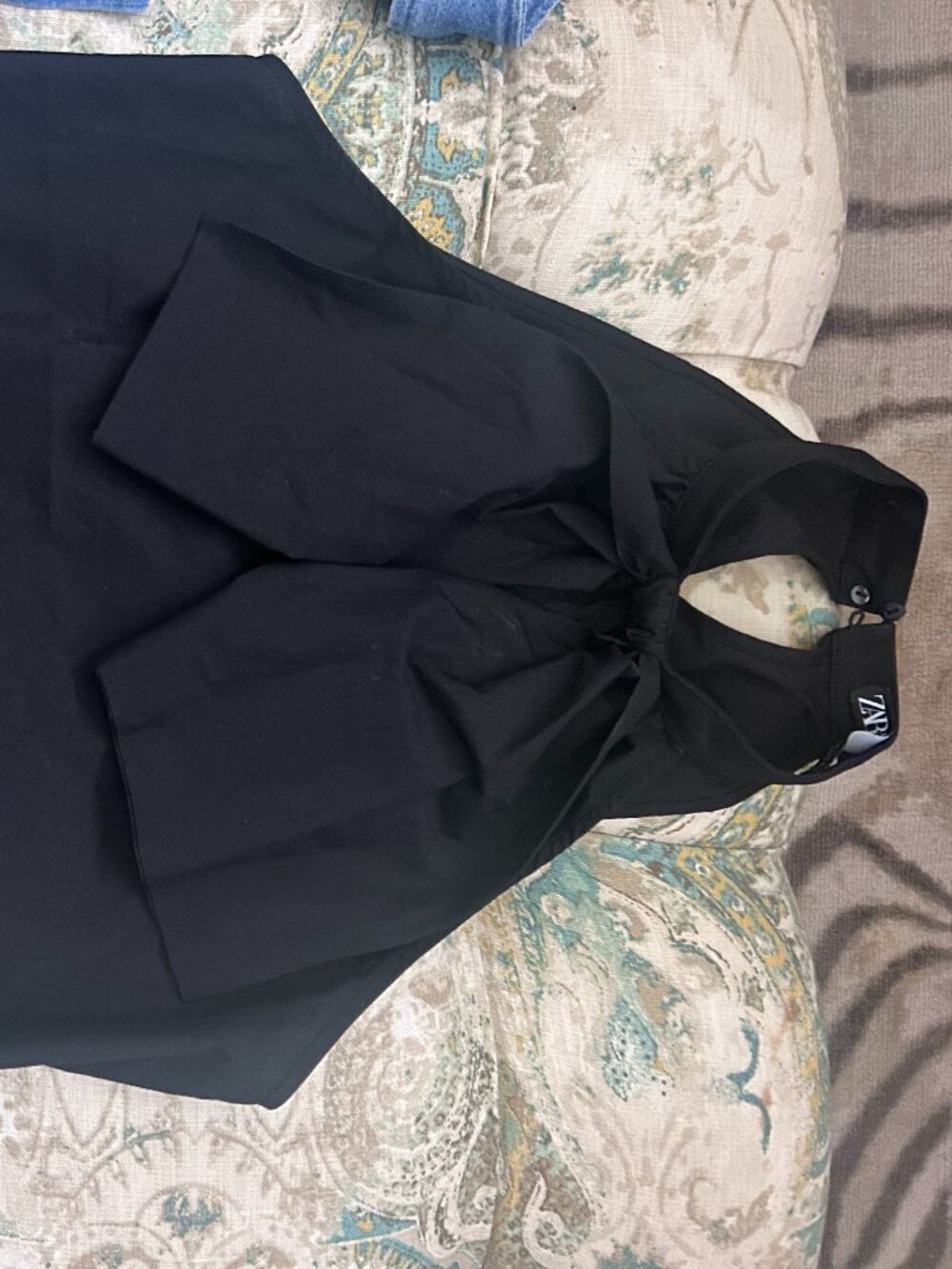 Black Zara halterneck top featuring a prominent front knot and bow detail